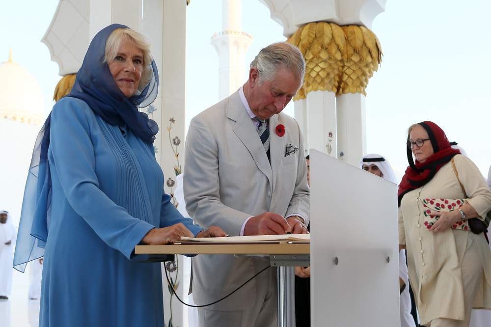 Prince Charles and the Duchess of Cornwall sign the mosque&#39;s guest book on their return visit in 2016. Photo Pawan Singh for the Crown Prince Court