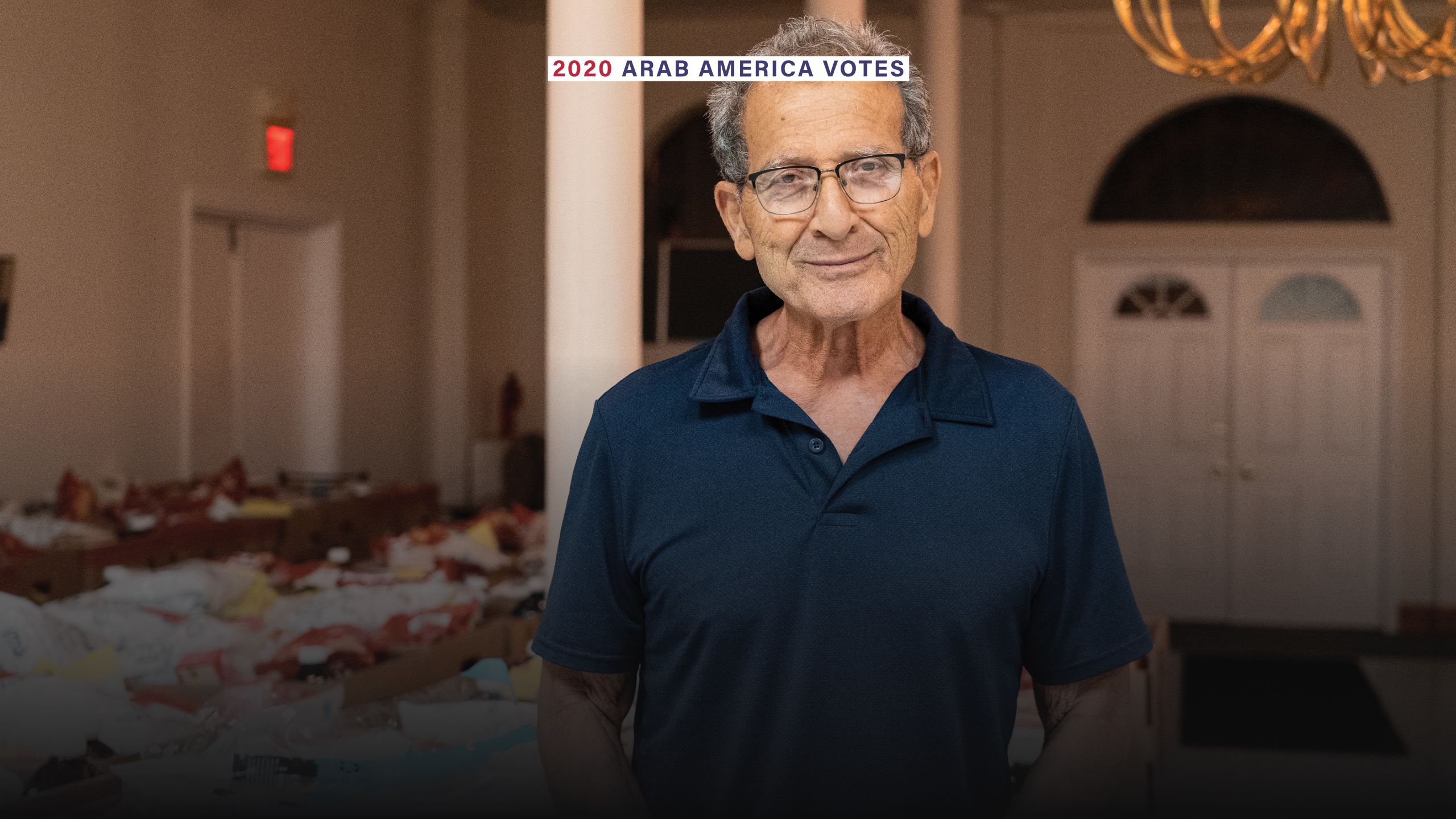 Radwan Jarrouj, 76, the treasurer of the Syrian Arab American Charity Association poses in front of food bank boxes for families in need. Sophie Tremblay / The National 