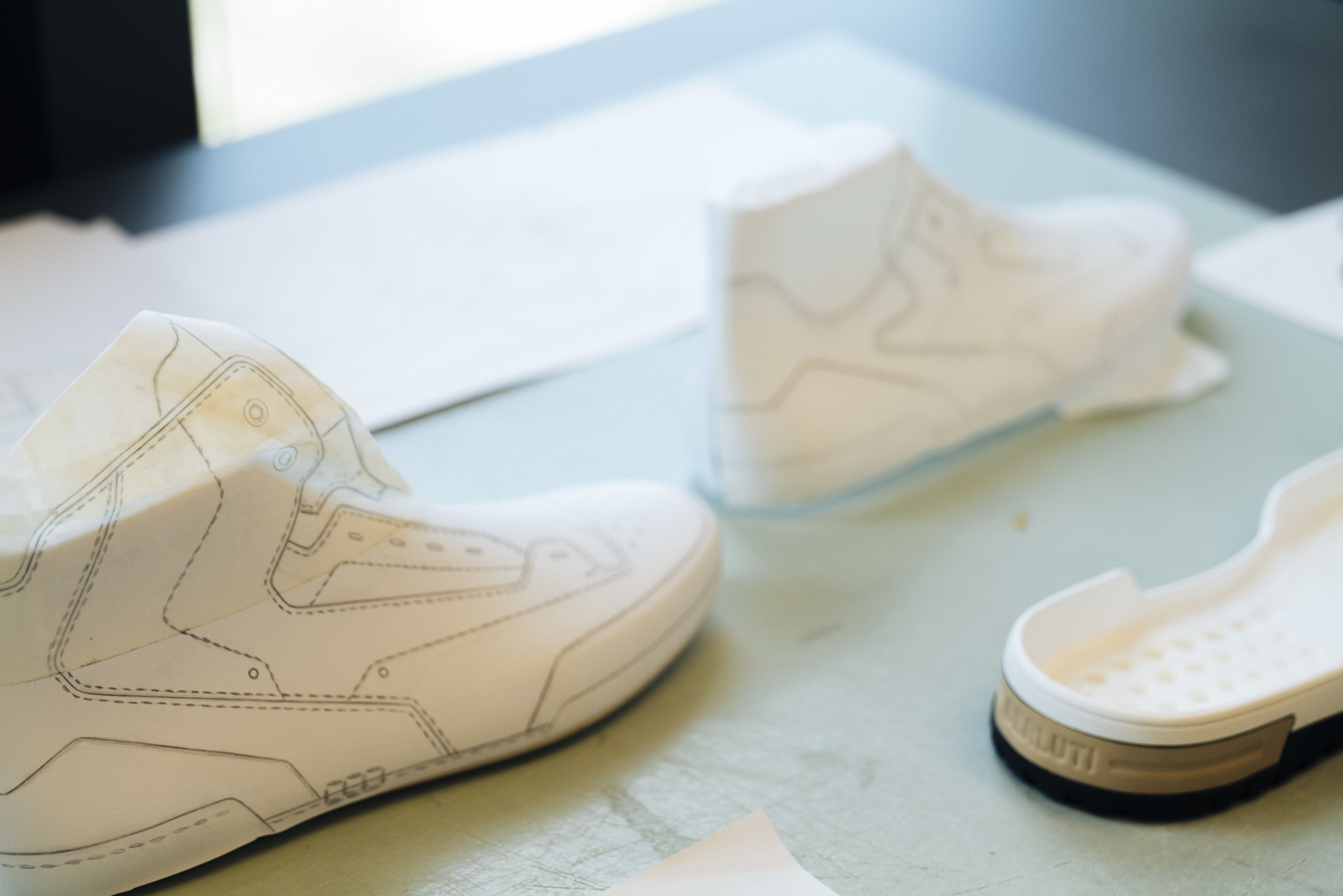 The shoe's design is traced onto paper in 2D, before being placed over a 3D model. Photo: Berluti