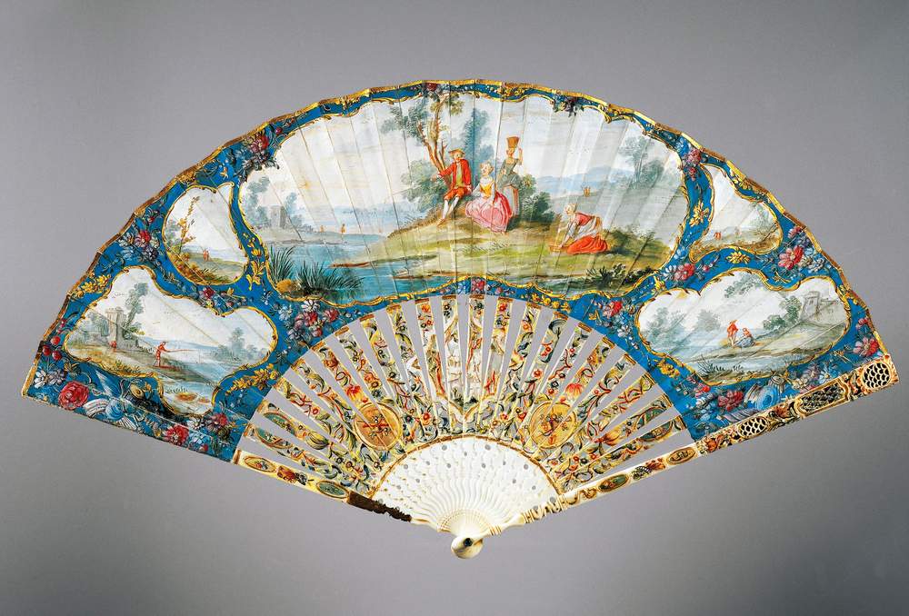 A hand-painted paper fan with decorated ivory ribs from 1760’s France.
Left, Queen Elizabeth I’s portrait includes a fan fashioned from feathers&amp;nbsp;