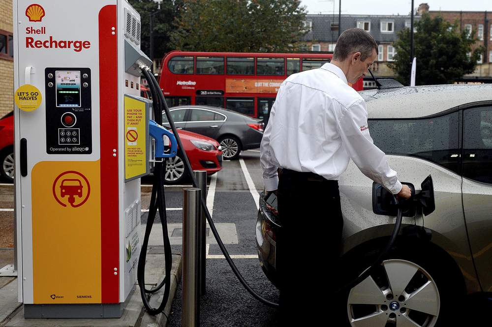 A member of staff charges an electric car at the Holloway Road Shell station where Shell launched its first fast electric vehicle charging station in London. 
Photo: Reuters