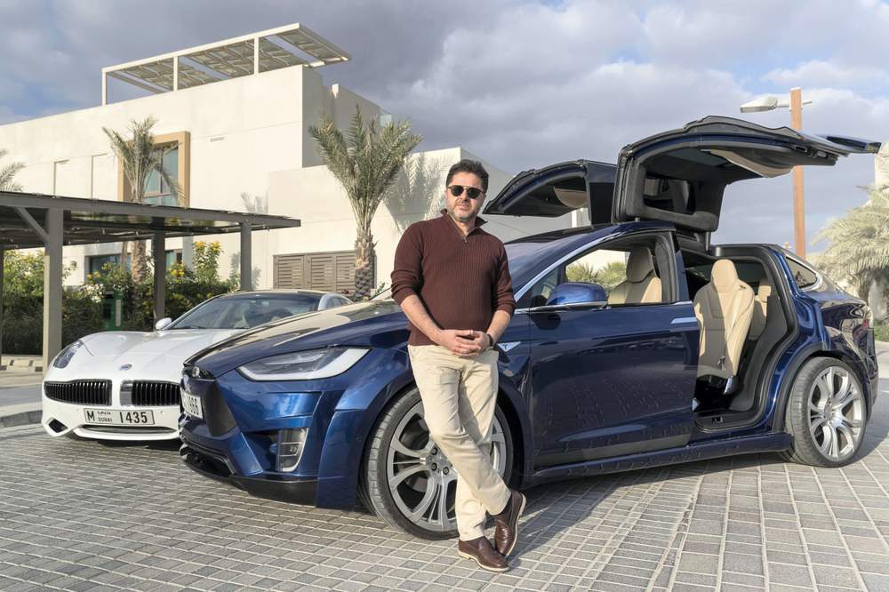 &amp;nbsp;Faris Saeed, the developer behind Sustainable City,&amp;nbsp;with his Fisker and Telsa EVs.&amp;nbsp;Photo: Antonie Robertson\/The National&amp;nbsp;