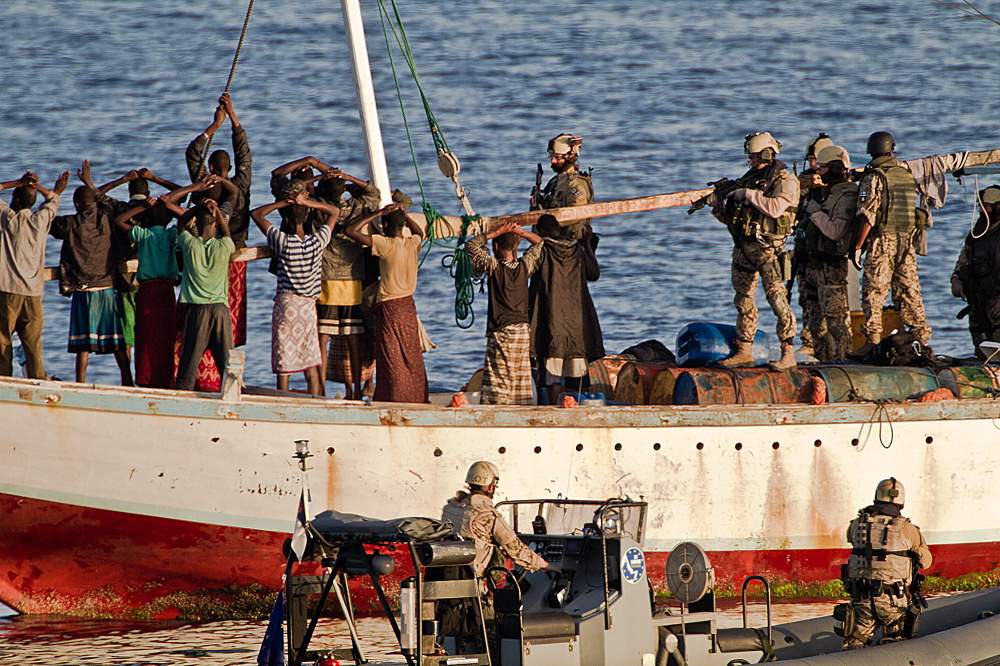 Boarding team approaches a hijacked dhow off Oman. AFP